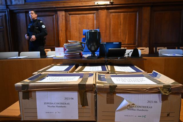 (FILES) A French gendarme stands by folders at the Vesoul courthouse on the first day of the appeal trial of Nicolas Zepeda, a Chilean man accused of allegedly murdering his Japanese ex-girlfriend in France in 2016, in Vesoul, eastern France, on February 21, 2023. Chilean national Nicolas Zepeda, accused of murdering his Japanese ex-girlfriend in Besançon will face his third trial at the assize court in Lyon on March 17, 2026. (Photo by Sébastien BOZON / AFP)