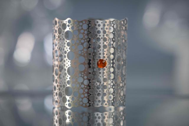 This picture presents piece of artistic jewellery designed and created by student of Experimental Design Stuio on Academy of Fine Arts in Gdansk, Poland on March 10, 2026. Long coveted for its golden color, scientific value, and alleged healing properties, amber is now coming into the hand of young Polish jewelers, bringing the ancient resin into modern times. Together with drills, sanders, blasters, and power saws which look like they belong to a bygone era, virtual reality stations are used to combine earlier tools with state-of-the-art technology at the Academy of Fine Arts in Gdansk, a city on Poland's Baltic Coast known as amber's global capital. (Photo by Wojtek RADWANSKI / AFP)