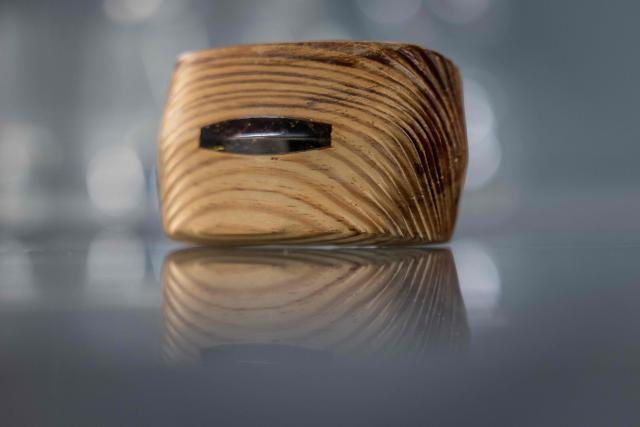 This picture presents piece of artistic jewellery made of natural Baltic amber, designed and created by student of Experimental Design Stuio on Academy of Fine Arts in Gdansk, Poland on March 10, 2026. Long coveted for its golden color, scientific value, and alleged healing properties, amber is now coming into the hand of young Polish jewelers, bringing the ancient resin into modern times. Together with drills, sanders, blasters, and power saws which look like they belong to a bygone era, virtual reality stations are used to combine earlier tools with state-of-the-art technology at the Academy of Fine Arts in Gdansk, a city on Poland's Baltic Coast known as amber's global capital. (Photo by Wojtek RADWANSKI / AFP)