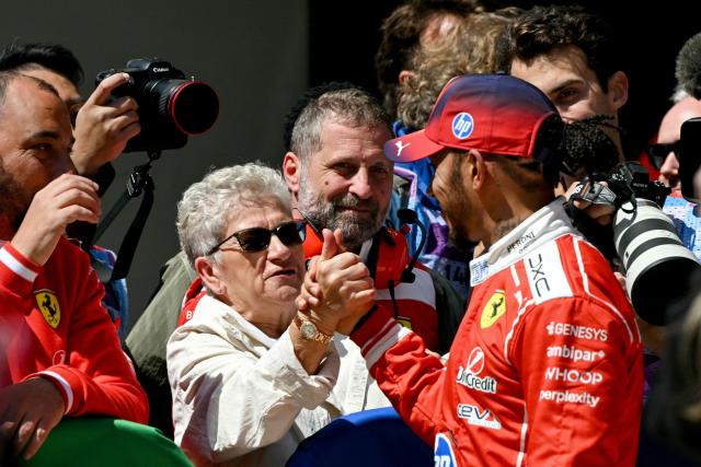 Third-placed Ferrari's British driver Lewis Hamilton greets fans after the sprint race ahead of the Formula One Chinese Grand Prix at the Shanghai International Circuit in Shanghai on March 14, 2026. (Photo by Greg Baker / AFP)