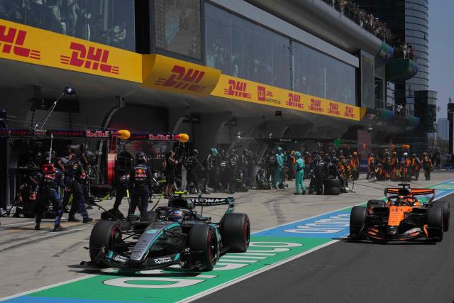 Mercedes' Italian driver Kimi Antonelli (L) out of the pits next to McLaren's Australian driver Oscar Piastri (R) during the sprint race ahead of the Formula One Chinese Grand Prix at the Shanghai International Circuit in Shanghai on March 14, 2026. (Photo by Andy Wong / POOL / AFP)