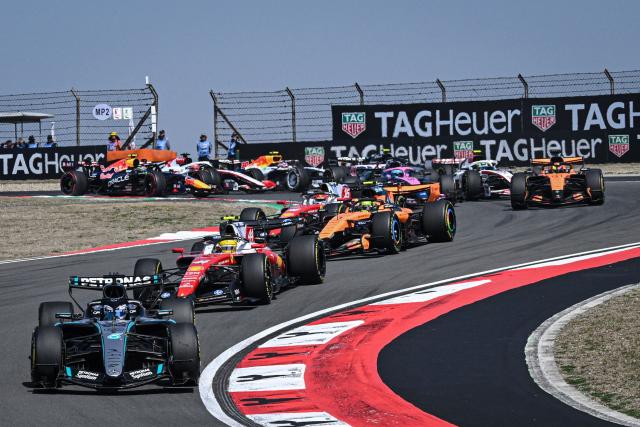 Mercedes' British driver George Russell (front L) leads at the start of the sprint race ahead of the Formula One Chinese Grand Prix at the Shanghai International Circuit in Shanghai on March 14, 2026. (Photo by Jade GAO / AFP)