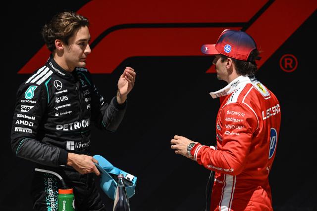 Sprint winner Mercedes' British driver George Russell (L) talks with Ferrari's Monegasque driver Charles Leclerc after the sprint race ahead of the Formula One Chinese Grand Prix at the Shanghai International Circuit in Shanghai on March 14, 2026. (Photo by Jade GAO / AFP)