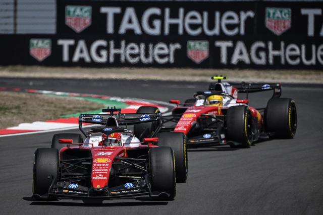 Ferrari's Monegasque driver Charles Leclerc drives in front of Ferrari's British driver Lewis Hamilton during the sprint race ahead of the Formula One Chinese Grand Prix at the Shanghai International Circuit in Shanghai on March 14, 2026. (Photo by Jade GAO / AFP)