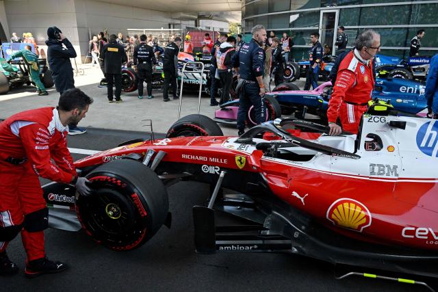 Crew members move the car of Ferrari's British driver Lewis Hamilton after the sprint race ahead of the Formula One Chinese Grand Prix at the Shanghai International Circuit in Shanghai on March 14, 2026. (Photo by GREG BAKER / AFP)