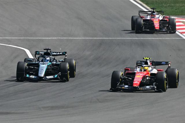 Mercedes' British driver George Russell (L), Ferrari's British driver Lewis Hamilton (R) and Ferrari's Monegasque driver Charles Leclerc (back) compete during the sprint race ahead of the Formula One Chinese Grand Prix at the Shanghai International Circuit in Shanghai on March 14, 2026. (Photo by Greg Baker / AFP)
