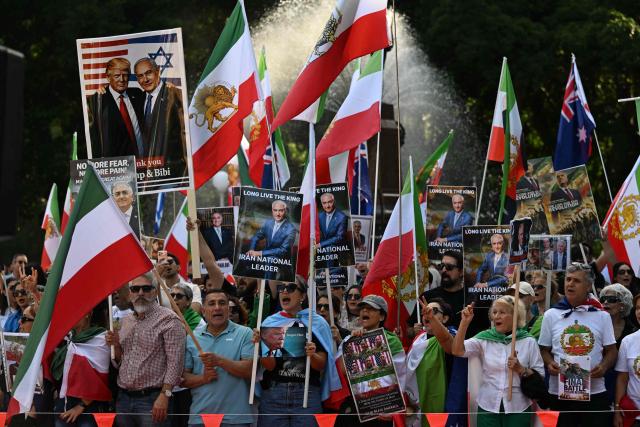Members of the Iranian community hold placards, wave flags and chant slogans during a rally following US and Israeli attacks on Iran, in Sydney on March 14, 2026. (Photo by Saeed KHAN / AFP)