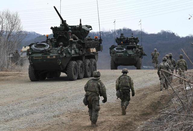US Stryker infantry carrier vehicles participate in a combined maneuver training with wet gap crossing during the 2026 South Korea-US Freedom Shield military exercise in Yeoncheon on March 14, 2026. (Photo by Jung Yeon-je / AFP)