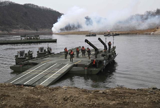 South Korean soldiers control KM3 Amphibious Rigs, self-propelled bridging vehicle, as they participate in a combined maneuver training with wet gap crossing during the 2026 South Korea-US Freedom Shield military exercise in Yeoncheon on March 14, 2026. (Photo by Jung Yeon-je / AFP)