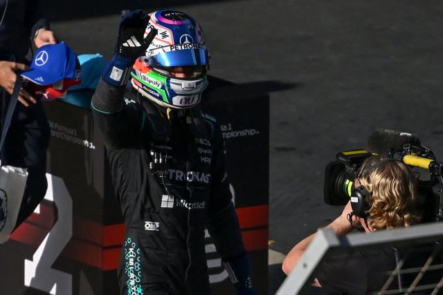 Mercedes' Italian driver Kimi Antonelli waves to a camera as he celebrates getting pole position in the qualifying session ahead of the Formula One Chinese Grand Prix at the Shanghai International Circuit in Shanghai on March 14, 2026. (Photo by JADE GAO / AFP)