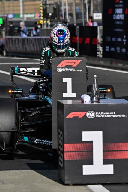 Mercedes' Italian driver Kimi Antonelli exits his car after taking the pole position during the qualifying session ahead of the Formula One Chinese Grand Prix at the Shanghai International Circuit in Shanghai on March 14, 2026. (Photo by Hector RETAMAL / AFP)