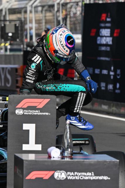 Mercedes' Italian driver Kimi Antonelli exits his car after taking the pole position during the qualifying session ahead of the Formula One Chinese Grand Prix at the Shanghai International Circuit in Shanghai on March 14, 2026. (Photo by Hector RETAMAL / AFP)