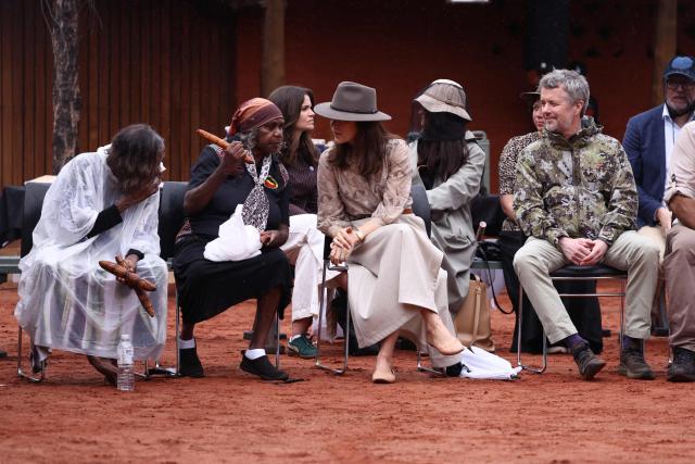 Denmark's King Frederik X (R) and Queen Mary (C) watch a ceremonial song and dance at the Uluru-Kata Tjuta National Park Cultural Centre at Uluru on March 14, 2026, during their five-day state visit to Australia. (Photo by David GRAY / POOL / AFP)