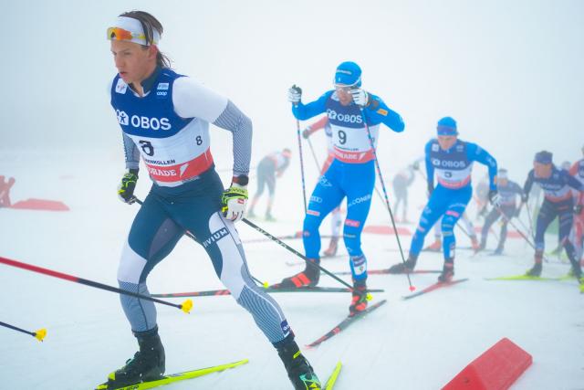 Savelii Korostelev (L) and Italy's Federico Pellegrino (9) and others compete during fog in the men's mass start 50km free race of the FIS Cross-Country World Cup in Holmenkollen, Oslo on March 14, 2026. (Photo by Terje Pedersen / NTB / AFP) / Norway OUT