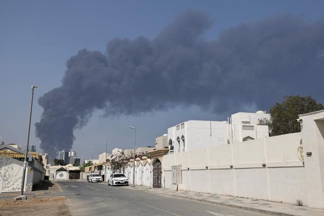 Smoke rises from the direction of an energy installation in the Gulf emirate of Fujairah on March 14, 2026. Smoke could be seen rising from the direction of a major UAE energy installation on March 14, in what appeared to be the latest strike targeting the Gulf's petroleum facilities hours after the US struck Iran's Kharg Island. (Photo by AFP) / 