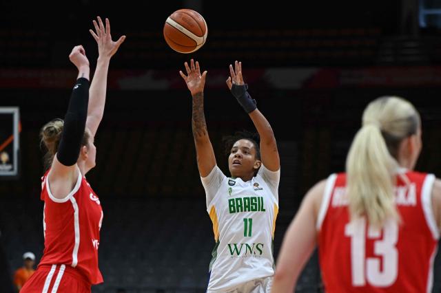 Brazil's Emanuely Oliveira (C) shoots as Czech Republic's Julia Reisingerova (L) blocks during the FIBA Women's Basketball World Cup 2026 qualifying tournament match between Brazil and Czech Republic in Wuhan, in central China's Hubei province on March 14, 2026. (Photo by CN-STR / AFP)