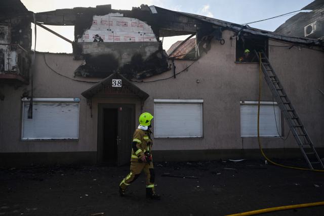 Firefighters work at a site of a strike in the town of Brovary, near Kyiv, following a Russian missile and drone attack, on March 14, 2026, amid the Russian invasion of Ukraine. Russian drone and missile strikes near Ukraine's capital killed two people and wounded four, the regional military administration said on March 14. "Sadly, two people have been killed in the Brovary Raion. Four more have been injured," said Mykola Kalashnyk, the head of Kyiv region's military administration, in a post on Telegram. (Photo by Genya SAVILOV / AFP)