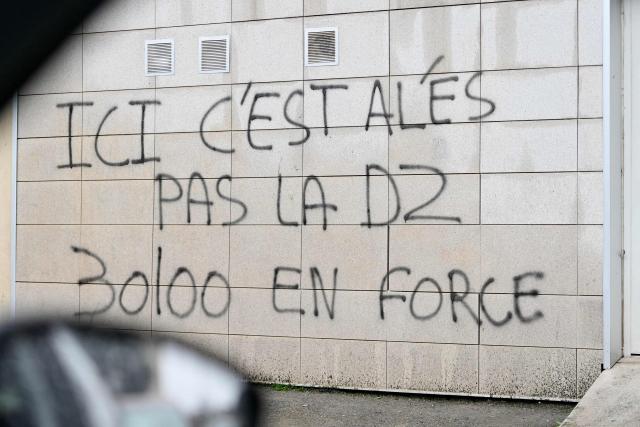 (FILES) This photograph shows inscriptions on a wall at the Cevennes district in Ales, southern France on January 22, 2026, during a visit of drug dealing spots by French prosecutors. The "unprecedented" operation against the DZ Mafia, carried out earlier this week by some 900 gendarmes, resulted in 26 people being charged, including two rappers and a lawyer suspected of corruption who has been remanded in custody, announced the Marseille public prosecutor March 14, 2026. (Photo by Sylvain THOMAS / AFP)