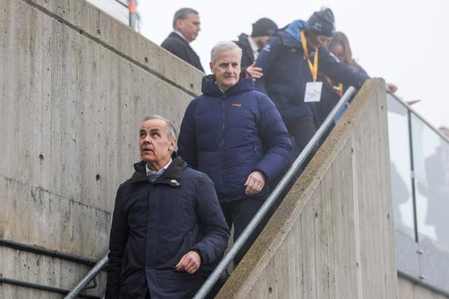 (L) Canadian Prime Minister Mark Carney and Norway's Prime Minister Jonas Gahr Store (2nd L) attend the FIS Cross-Country World Cup in Holmenkollen, Oslo on March 14, 2026. (Photo by Christoffer Andersen / NTB / AFP) / Norway OUT