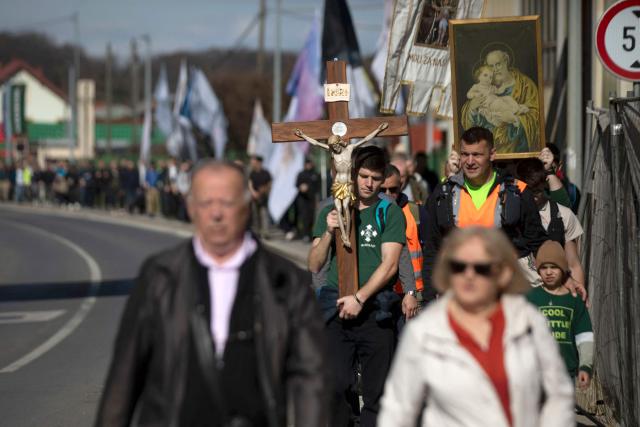 Dozens of Croatian conservative Catholics march in the streets of Croatian city of Karlovac, on March 14, 2026. The prayers, led by the conservative Catholic men's group "Be Manly", have been held across Croatia on the first Saturday of every month since 2022. They have attracted a small but dedicated following in the staunchly Catholic nation of 3.8 million people, where traditional values are widespread. (Photo by DANIEL KASAP / AFP)