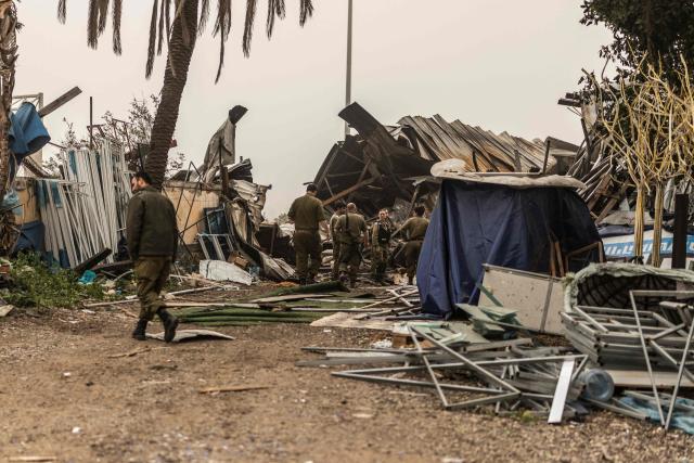 Home front Israeli soldiers check the damage the day after a strike on the outskirts of Tel Aviv on March 14, 2026. On February 28, Israel and the United States launched strikes on Iran, killing its supreme leader and triggering a war that spread across the Middle East. (Photo by Ilia YEFIMOVICH / AFP) / 
