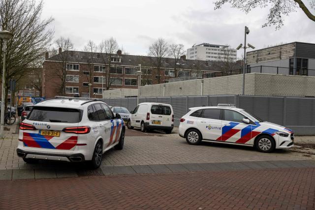 Police vehicles are parked outside a Jewish school where an explosion was reported overnight in Amsterdam on March 14, 2026. An overnight blast against an exterior wall of a Jewish school in Amsterdam did not cause any injuries, Mayor Femke Halsema said March 14, 2026, denouncing "a cowardly act of aggression". An investigation has been opened and the incident comes after nighttime attacks this week in front of synagogues in the Belgian city of Liege and the Dutch port city of Rotterdam. (Photo by Michel van Bergen / ANP / AFP) / Netherlands OUT