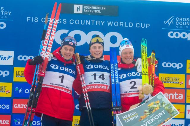 (L-R) Second placed Norway's Harald Ostberg Amundsen, first placed Norway's Einar Hedegart and third placed Norway's Martin Lowstrom Nyenget celebrate on the podium after winning the men's mass start 50km free race of the FIS Cross-Country World Cup in Holmenkollen, Oslo, Norway, on March 14, 2026. (Photo by Terje Pedersen / NTB / AFP) / Norway OUT