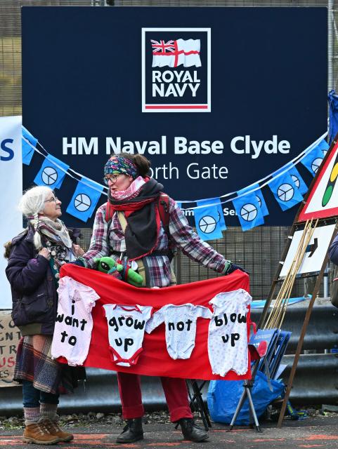 Protestors take part in a demonstration organised by the Scottish Campaign for Nuclear Disarmament (CND), outside HM Naval Base Clyde at Faslane, north-west of Glasgow, Scotland on March 14, 2026. (Photo by ANDY BUCHANAN / AFP)