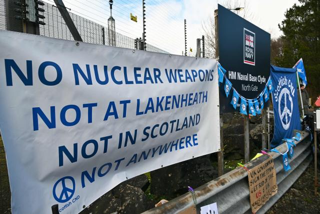 Protestors take part in a demonstration organised by the Scottish Campaign for Nuclear Disarmament (CND), outside HM Naval Base Clyde at Faslane, north-west of Glasgow, Scotland on March 14, 2026. (Photo by ANDY BUCHANAN / AFP)