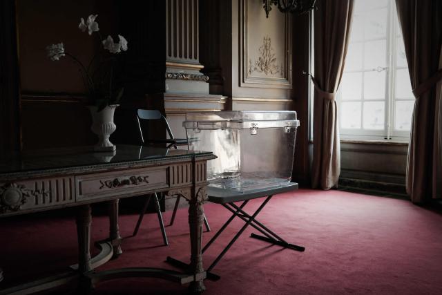 A transparent ballot box is set up in the wedding hall of Bordeaux City Hall in Bordeaux, south-western France, on March 14, 2026, on the eve of the first round of France's municipal elections. (Photo by Philippe LOPEZ / AFP)