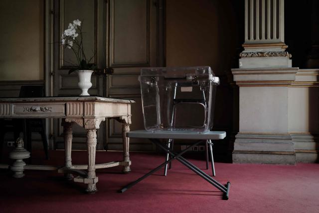 A transparent ballot box is set up in the wedding hall of Bordeaux City Hall in Bordeaux, south-western France, on March 14, 2026, on the eve of the first round of France's municipal elections. (Photo by Philippe LOPEZ / AFP)