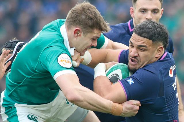 Scotland's centre Sione Tuipulotu (R) vies for the ball during the Six Nations international rugby union match between Ireland and Scotland at the Aviva Stadium in Dublin, on March 14, 2026. (Photo by Paul Faith / AFP)