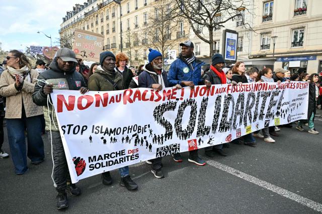 Protesters hold a banner as they demonstrate during a rally against racism, fascism and state violence, in Paris on March 14, 2026. Some 85 rallies have been announced throughout France for March 14, on the eve of a highly uncertain local election. The vote serves as a test one year ahead of the 2027 presidential election, particularly for the far right, which hopes to build on its momentum. (Photo by Martin LELIEVRE / AFP)