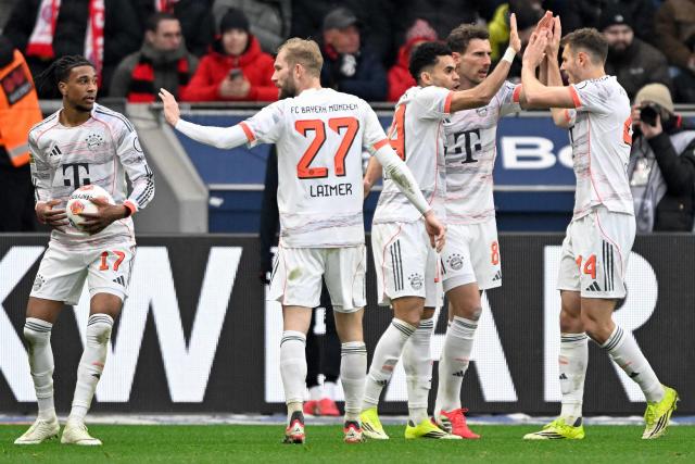 Bayern Munich's Colombian forward #14 Luis Diaz (3rd R) celebrates scoring the 1-1 goal with his teammates during the German first division Bundesliga football match between Bayer 04 Leverkusen and FC Bayern Munich in Leverkusen, western Germany on March 14, 2026. (Photo by INA FASSBENDER / AFP) / DFL REGULATIONS PROHIBIT ANY USE OF PHOTOGRAPHS AS IMAGE SEQUENCES AND/OR QUASI-VIDEO