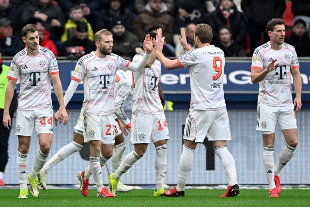 Bayern Munich's Colombian forward #14 Luis Diaz (C) celebrates scoring the 1-1 goal with his teammates during the German first division Bundesliga football match between Bayer 04 Leverkusen and FC Bayern Munich in Leverkusen, western Germany on March 14, 2026. (Photo by INA FASSBENDER / AFP) / DFL REGULATIONS PROHIBIT ANY USE OF PHOTOGRAPHS AS IMAGE SEQUENCES AND/OR QUASI-VIDEO