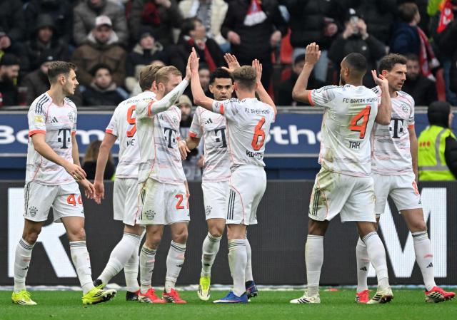 Bayern Munich's Colombian forward #14 Luis Diaz (C) celebrates scoring the 1-1 goal with his teammates during the German first division Bundesliga football match between Bayer 04 Leverkusen and FC Bayern Munich in Leverkusen, western Germany on March 14, 2026. (Photo by INA FASSBENDER / AFP) / DFL REGULATIONS PROHIBIT ANY USE OF PHOTOGRAPHS AS IMAGE SEQUENCES AND/OR QUASI-VIDEO