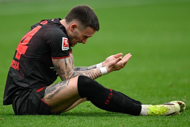 Bayer Leverkusen's Spanish midfielder #24 Aleix Garcia reacts after sustaining an injury during the German first division Bundesliga football match between Bayer 04 Leverkusen and FC Bayern Munich in Leverkusen, western Germany on March 14, 2026. (Photo by INA FASSBENDER / AFP) / DFL REGULATIONS PROHIBIT ANY USE OF PHOTOGRAPHS AS IMAGE SEQUENCES AND/OR QUASI-VIDEO
