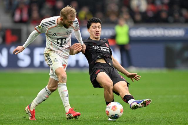 Bayern Munich's Austrian midfielder #27 Konrad Laimer (L) and Bayer Leverkusen's Algerian midfielder #30 Ibrahim Maza vie for the ball during the German first division Bundesliga football match between Bayer 04 Leverkusen and FC Bayern Munich in Leverkusen, western Germany on March 14, 2026. (Photo by INA FASSBENDER / AFP) / DFL REGULATIONS PROHIBIT ANY USE OF PHOTOGRAPHS AS IMAGE SEQUENCES AND/OR QUASI-VIDEO