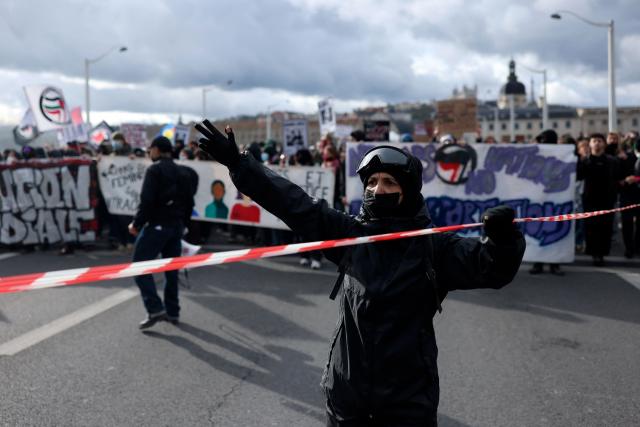 A protester chants during a march to protest against racism and fascism in Lyon, southeastern France, on March 14, 2026. Some 85 rallies have been announced throughout France for March 14, on the eve of a highly uncertain local election. The vote serves as a test one year ahead of the 2027 presidential election, particularly for the far right, which hopes to build on its momentum. (Photo by Alex MARTIN / AFP)