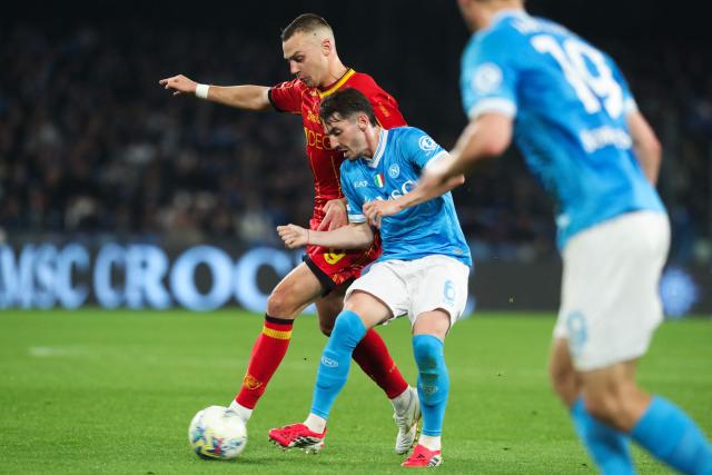 Napoli's Scottish midfielder #6 Billy Gilmour (C) fights for the ball with Lecce's Serbian forward #9 Nikola Stulic during the Italian Serie A football match between Napoli and Lecce at the Diego Armando Maradona stadium in Naples, southern Italy, on March 14, 2026. (Photo by CARLO HERMANN / AFP)