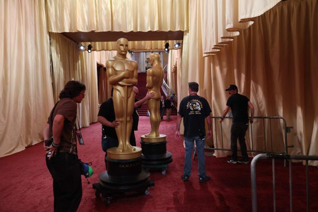 Workers move Oscar statues ahead of the 98th Annual Academy Awards at the Dolby Theatre in Hollywood, California, on March 14, 2026. (Photo by ANGELA WEISS / AFP)