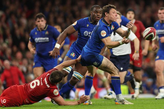 Italy's fly-half Paolo Garbisi passes the ball as he is tackled by Wales' flanker Alex Mann during the Six Nations international rugby union match between Wales and Italy at the Principality Stadium in Cardiff, southern Wales on March 14, 2026. (Photo by Adrian Dennis / AFP)