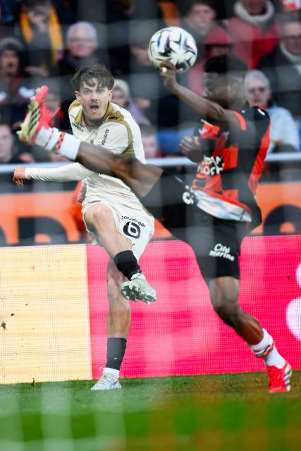 Lens' French midfielder #26 Anthony Fabien Bermont (L) fights for the ball with Lorient's Senegalese defender #25 Abdoulaye Faye during the French L1 football match between FC Lorient and RC Lens at Yves-Allainmat stadium in Lorient, western France on March 14, 2026. (Photo by Loic VENANCE / AFP)