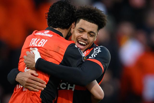 Lorient's players celebrate after winning the French L1 football match between FC Lorient and RC Lens at Yves-Allainmat stadium in Lorient, western France on March 14, 2026. (Photo by Loic VENANCE / AFP)