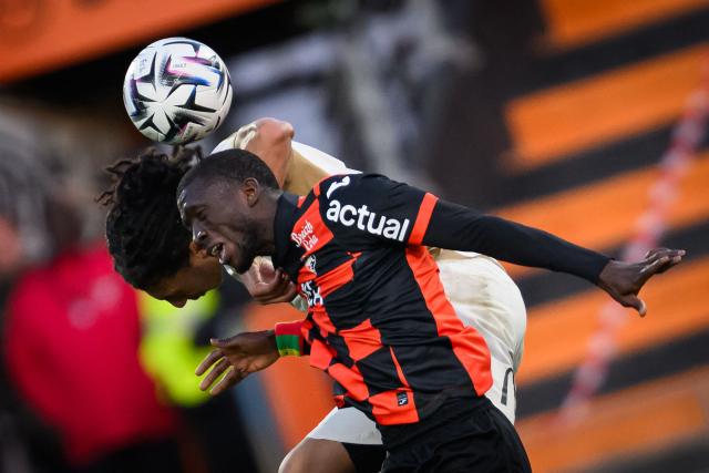 Lorient's Senegalese forward #28 Sambou Soumano (R) fights for the ball with Lens' French defender Pierre Ismaelo Ganiou during the French L1 football match between FC Lorient and RC Lens at Yves-Allainmat stadium in Lorient, western France on March 14, 2026. (Photo by Loic VENANCE / AFP)