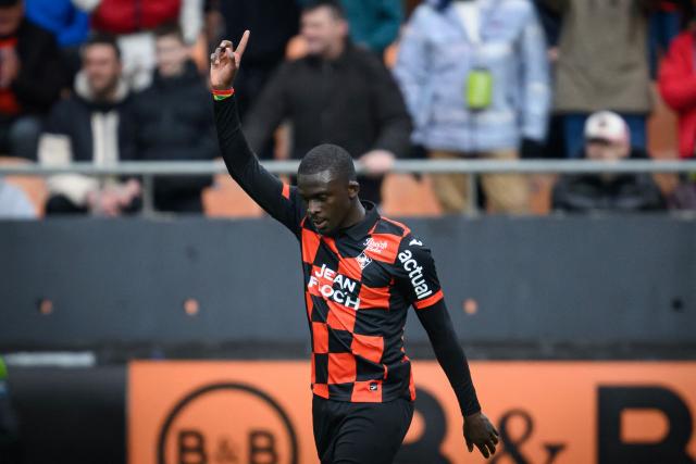 Lorient's Senegalese forward #12 Bamba Dieng celebrates scoring his team's first goal during the French L1 football match between FC Lorient and RC Lens at the Stade du Moustoir in Lorient, western France, on March 14, 2026. (Photo by Loic VENANCE / AFP)