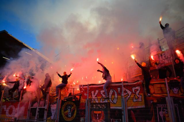 Lens' supporters light flares during the French L1 football match between FC Lorient and RC Lens at the Stade du Moustoir in Lorient, western France, on March 14, 2026. (Photo by Loic VENANCE / AFP)