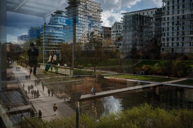Members of the public are reflected in a glass pane as others are seen walk on a sunny day in the Parc Clichy-Batignolles - Martin Luther King in Paris on March 14, 2026. (Photo by Dimitar DILKOFF / AFP)