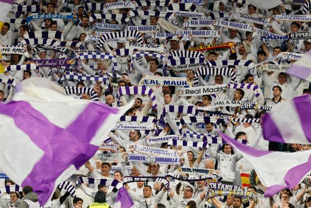 Real Madrid supporters cheer before the start of the Spanish league football match between Real Madrid CF and Elche CF at the Santiago Bernabeu Stadium in Madrid on March 14, 2026. (Photo by Oscar DEL POZO / AFP)