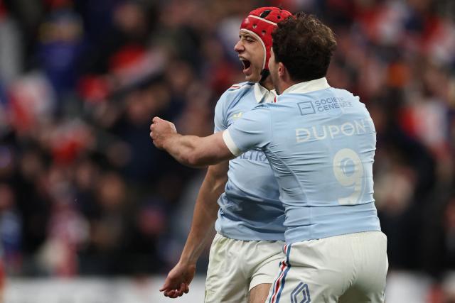 France's wing Louis Bielle-Biarrey (L) celebrates with France's scrum-half Antoine Dupont (R) after scoring France's first try during the Six Nations international rugby union match between France and England at the Stade de France, in Saint-Denis, north of Paris, on March 14, 2026. (Photo by FRANCK FIFE / AFP)